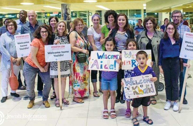 Volunteers with the Jewish Federation of Winnipeg wait at the airport to welcome Yazidi refugees from Iraq (photo credit: FACEBOOK)
