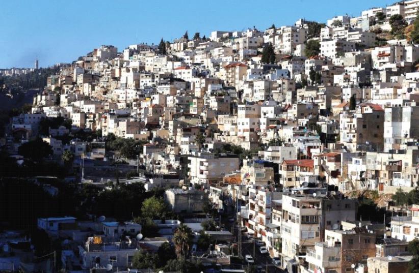 SILWAN, an Arab neighborhood close to Jerusalem’s Old City, one of many places the author claims Arab residents are being displaced from (photo credit: REUTERS)