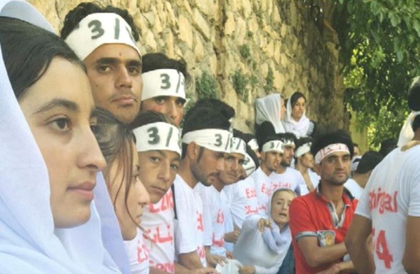 YAZIDI YOUTH demonstrate recently for the recognition of genocide by ISIS at the Lalish Temple in northern Iraq. (photo credit: SPRINGS OF HOPE FOUNDATION)