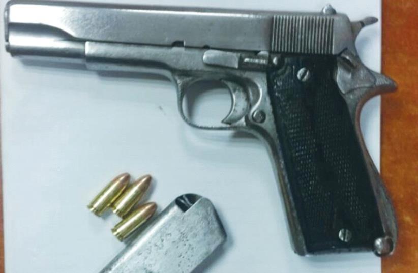 ARMY AND POLICE units seized this handgun, as well as other weapons, during an overnight raid in Hebron. (photo credit: IDF)