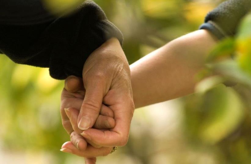  Adult and child holding hands (illustrative) (photo credit: ING IMAGE/ASAP)