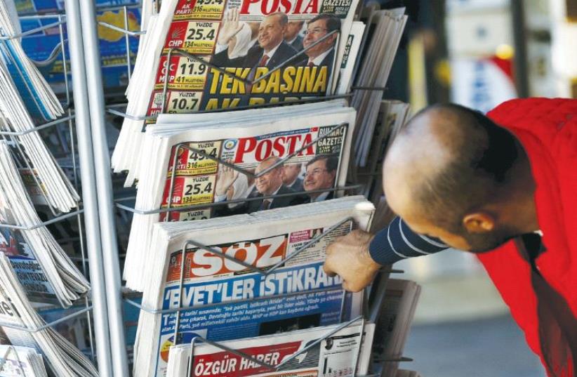 A man looks at newspapers at a kiosk in Diyarbakir in November 2015. Since the July 15 coup people have complained of a crackdown on press (photo credit: REUTERS)