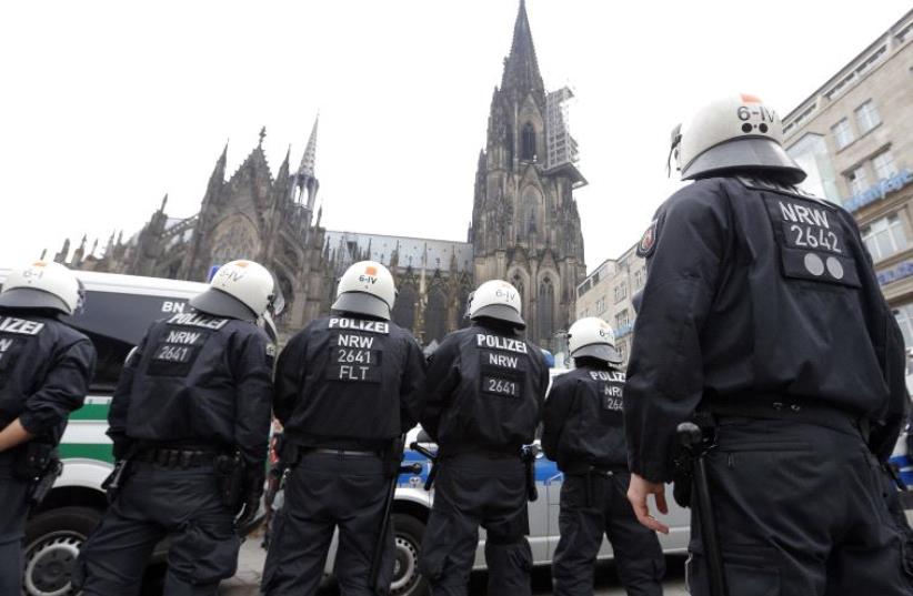 German riot police stand in front of the Cologne Cathedral (photo credit: REUTERS)