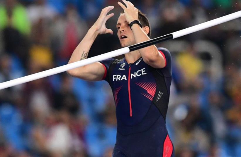 France's Renaud Lavillenie reacts after missing his final attempt during the Men's Pole Vault Final during the athletics event at the Rio 2016 Olympic Games at the Olympic Stadium in Rio de Janeiro on August 15, 2016 (photo credit: FRANCK FIFE / AFP)