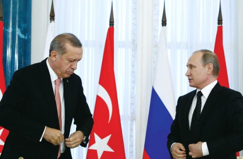 Russian President Vladimir Putin (right) and Turkish President Tayyip Erdogan attend a news conference following their meeting in St. Petersburg on August 9 (photo credit: REUTERS)