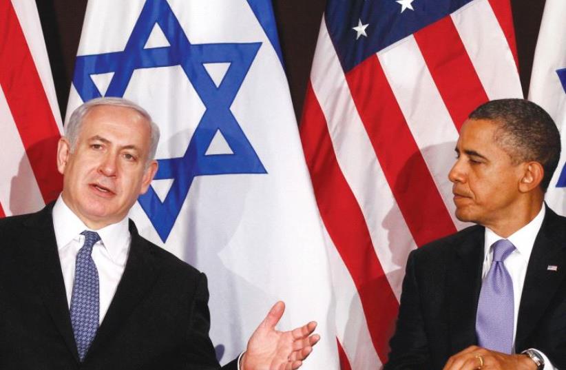 Benjamin Netanyahu and Barack Obama against a backdrop of Israeli flags and American flags (photo credit: KEVIN LAMARQUE/REUTERS)