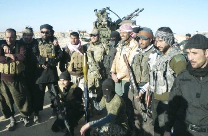 AL-JUGHAYA tribal members pause for a group photo while fighting ISIS under siege. (photo credit: Courtesy)