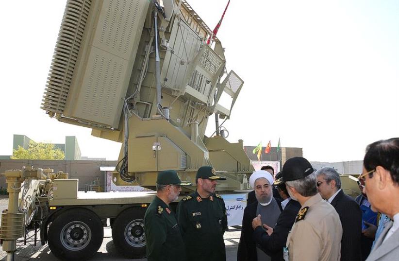 Iran's President Hassan Rouhani (3rd L) and Iranian Defence Minister Hossein Dehghan (2nd L) stand in front of the new air defense missile system Bavar-373, in Tehran, Iran August 21, 2016 (photo credit: REUTERS)