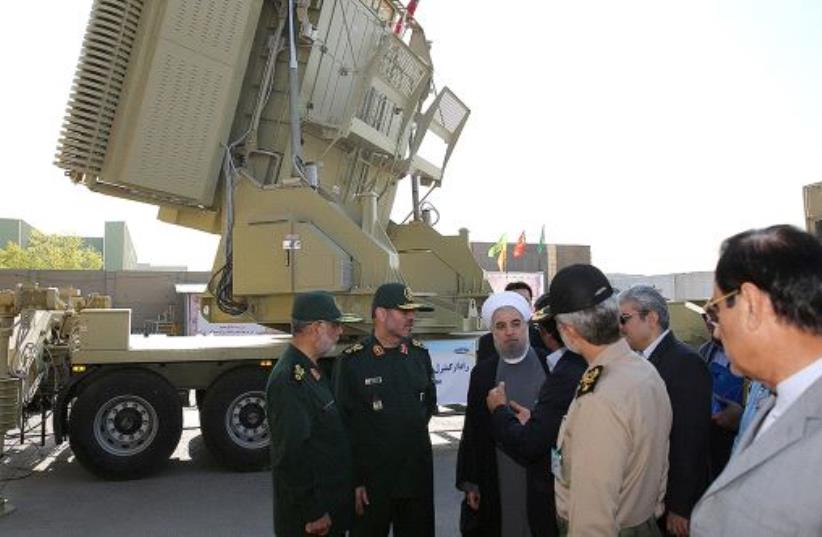 Iran's President Hassan Rouhani (3rd L) and Iranian Defence Minister Hossein Dehghan (2nd L) stand in front of the new air defense missile system Bavar-373, in Tehran, Iran August 21, 2016 (photo credit: REUTERS)