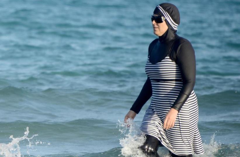 Tunisian women wearing a "burkini (photo credit: FETHI BELAID/AFP)