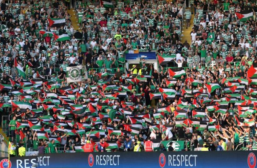 Celtic fans hold up Palestinian flags at EUFA Champions League Qualifying match versus Hapoel Beer-Sheva.  (photo credit: REUTERS)
