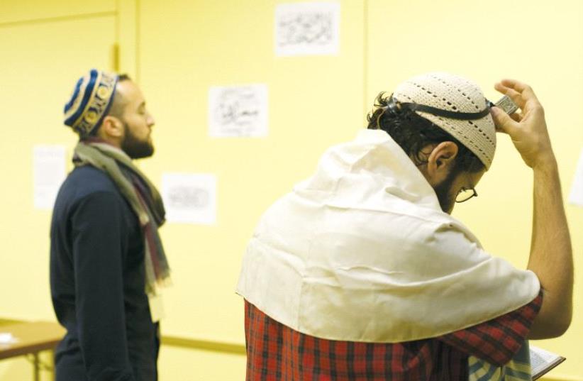 Muslim and Jewish participants in the seventh annual Muslim Jewish Conference perform Friday prayers (photo credit: DANIEL SHAKED)