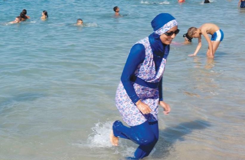 A WOMAN WEARS a burkini at a beach in Marseille yesterday. (photo credit: REUTERS)