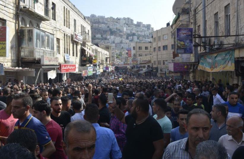 Thousands of participants in a funeral procession march on main thoroughfare in Nablus.  (photo credit: UDI SHAHAM)