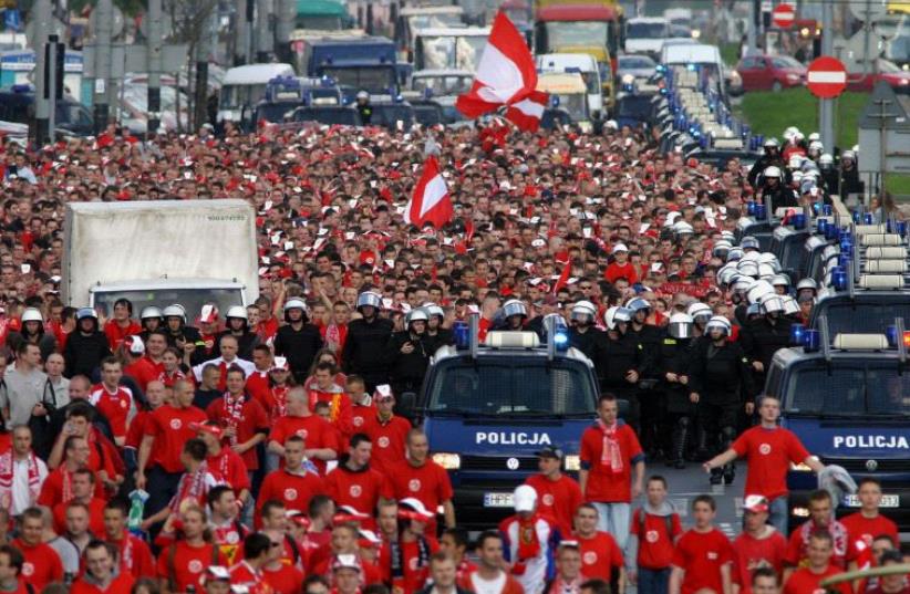 Polish soccer fans of the Widzew Lodz club escorted by police [File] (photo credit: REUTERS)