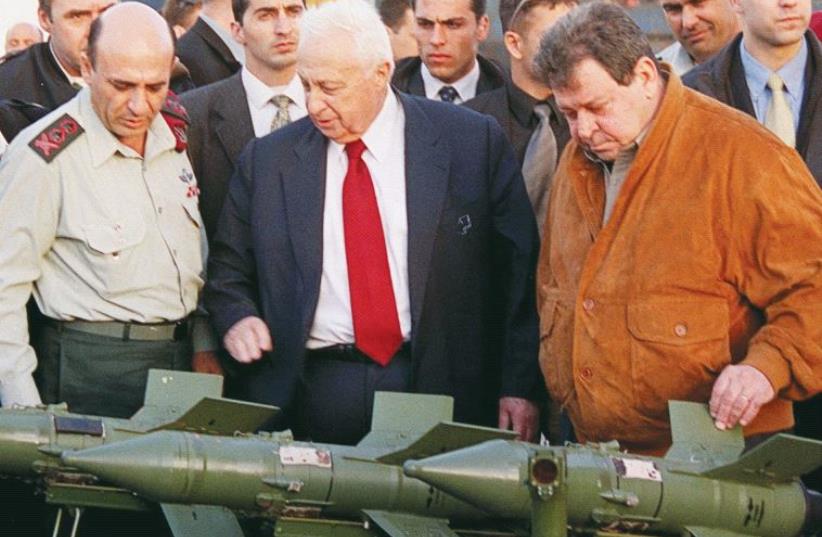 FORMER LEADERS (from left) chief of staff Shaul Mofaz, prime minister Ariel Sharon, and defense minister Binyamin Ben- Eliezer examine Sagger anti-tank missiles captured on the Palestinian arms ship ‘Karine A’ in January 2002. (photo credit: MOSHE MILNER / GPO)