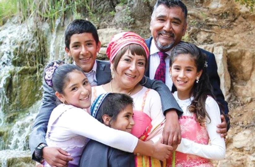 Batel Weisse-Gamzu (center), who moved to Beit El from Peru 16 years ago, with her husband, Yitzhak, and their four children (photo credit: BATEL WEISSE-GAMZU)