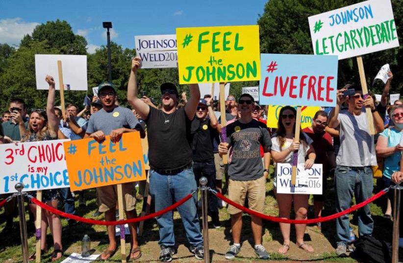 Supporters cheer at a campaign rally with Libertarian presidential candidate Gary Johnson and vice presidential candidate Bill Weld. (photo credit: REUTERS)