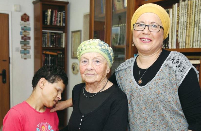 Chaviv Tzahor, founder of Neve Avraham, at her home in Kiryat Arba with her daughters Mina and Liat. (photo credit: GERSHON ELINSON)