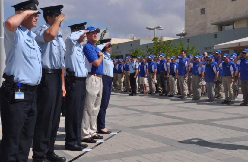 US and Israeli police officers salute each other during a Wednesday ceremony in Jerusalem’s Safra Square.  (photo credit: ISRAEL POLICE)