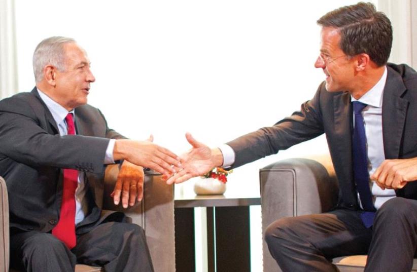 DUTCH PRIME Minister Mark Rutte and Prime Minister Benjamin Netanyahu shake hands during a meeting in the Hague, the Netherlands last week. (photo credit: REUTERS)