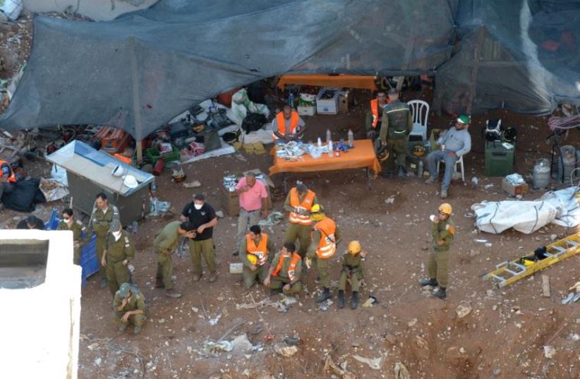 RESCUE PERSONNEL work at the disaster site in northeastern Tel Aviv (photo credit: AVSHALOM SASSONI)