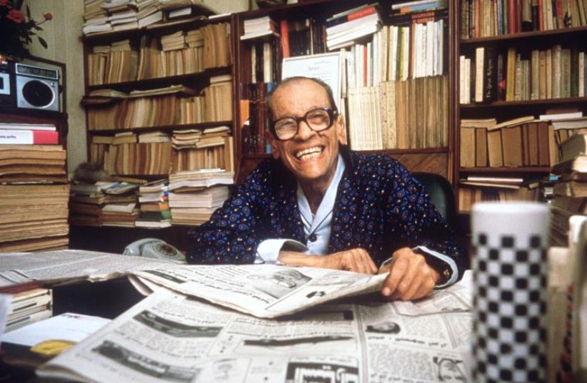 Naguib Mahfouz smiles in his Cairo home, 19 October 1988, a few days after the announcement of his award of the Nobel Prize in Literature (photo credit: PETER OFTEDAL / SCANPIX SWEDEN / AFP)