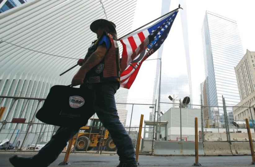 A man arrives at the World Trade Center complex on the morning of the 15th anniversary of the 9/11 attacks in Manhattan this week (photo credit: REUTERS)
