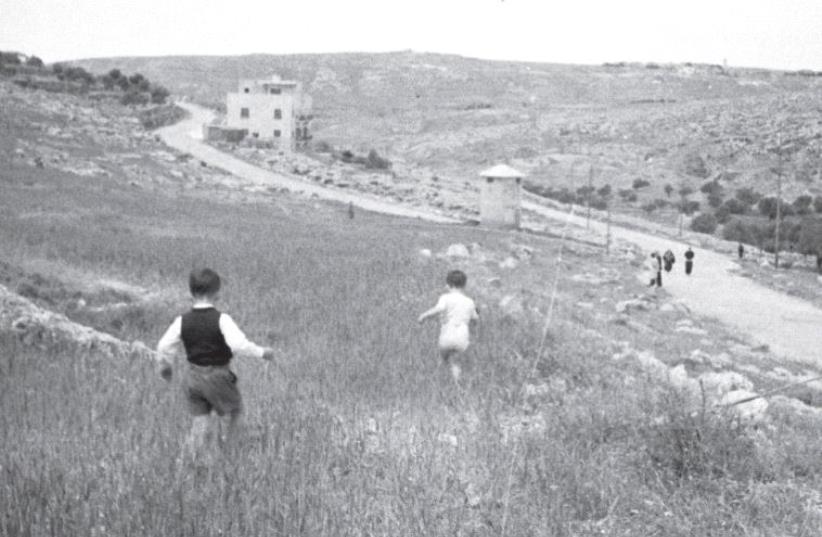 Children at play run toward a pillbox several decades ago (photo credit: CENTRAL ZIONIST ARCHIVES JERUSALEM/TIM GIDAL COLLECTION)