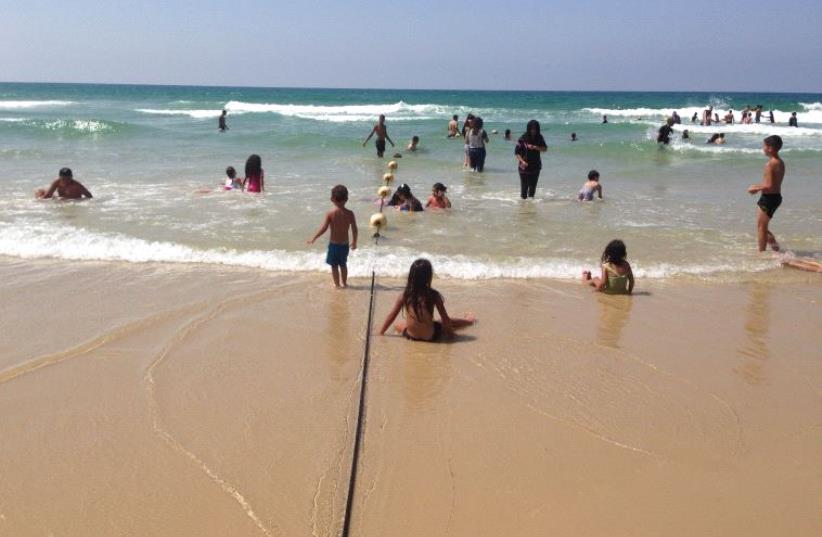 Palestinian children and their parents at Charles Clore Beach, September 15th  (photo credit: ELIYAHU KAMISHER)
