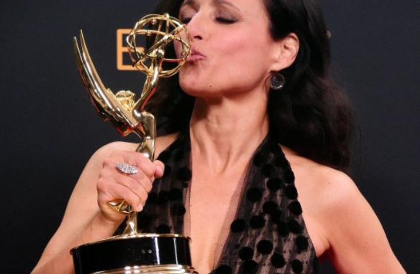Julia Louis-Dreyfus poses in the press room with the Emmy for Outstanding Lead Actress in a Comedy Series for "Veep"  (photo credit: FREDERIC J BROWN / AFP)