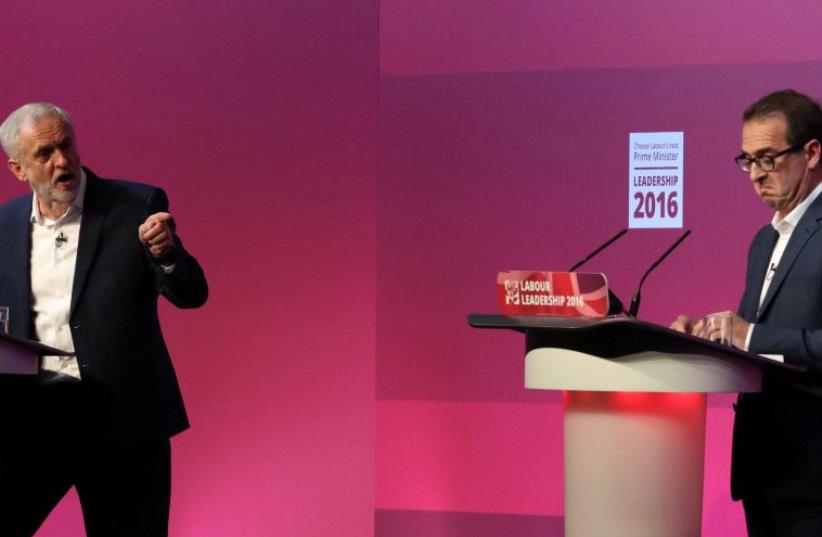Britain's Labour leader Jeremy Corbyn (L) gestures to Owen Smith during tonight's debate at a Labour Leadership Campaign event in Glasgow, Scotland, August 25, 2016. (photo credit: REUTERS/RUSSELL CHEYNE)