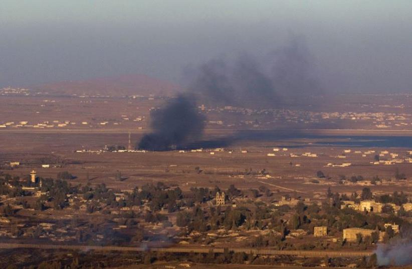 IS DETERRENCE working? Smoke rises last year on the Syrian side of the Golan Heights during fighting near the border. (photo credit: REUTERS)