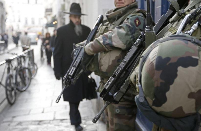 French soldiers patrol the street in a Jewish neighbourhood near a religious school and a synagogue as part of the highest level of "Vigipirate" security plan after the Islamist attacks in Paris January 20, 2015.  (photo credit: REUTERS)