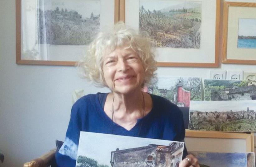 Helen Bar-Lev with her paintings. The unframed pictures are from her recent visit to Italy, while the framed ones depict the Israeli landscape (photo credit: JOHNMICHAEL SIMON)