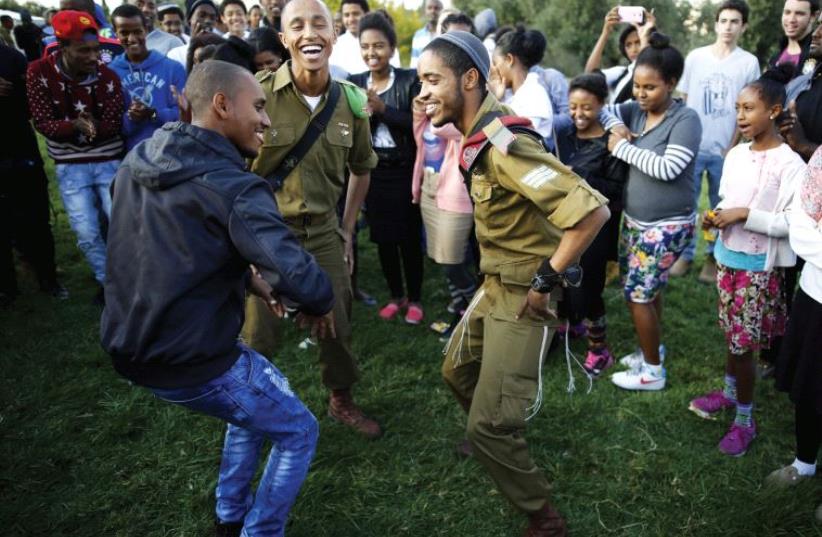 Members of the Ethiopian Jewish community in Israel dance during a ceremony marking the holiday of Sigd (photo credit: REUTERS)
