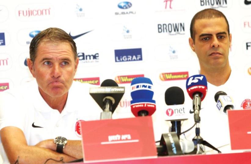 There were few smiles at yesterday’s press conference in which coach Guy Luzon (right) was unveiled as Eli Gutman’s replacement at Hapoel Tel Aviv, with the latter moving up to the front office following the team’s poor start to the campaign. (photo credit: DANNY MARON)