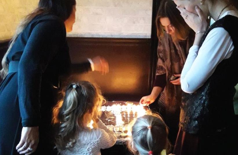 JEWISH WOMEN in Irpin, Ukraine, light Shabbat candles (photo credit: TAMARA ZIEVE)