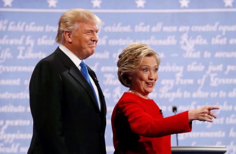 Donald Trump and Hillary Clinton look on at the start of their debate. (photo credit: REUTERS)