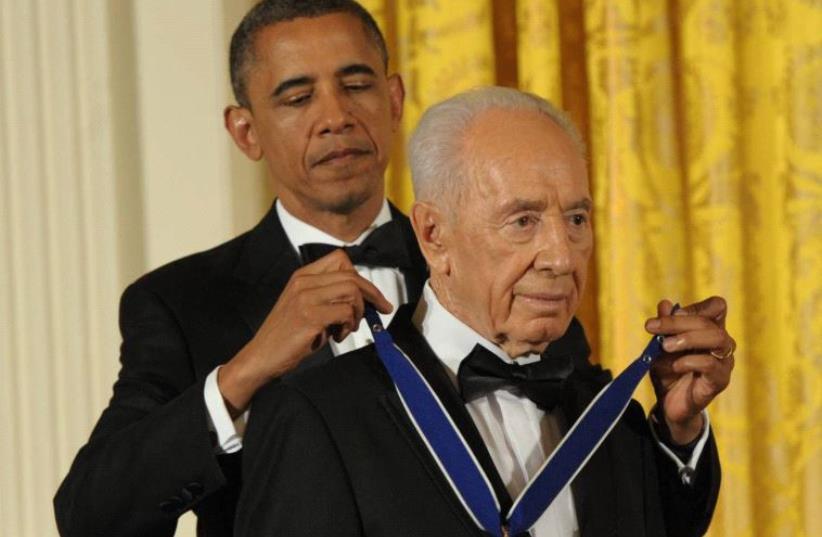 Barack Obama honors Shimon Peres with the Presidential Medal of Freedom at the White House in 2012 (photo credit: GPO)