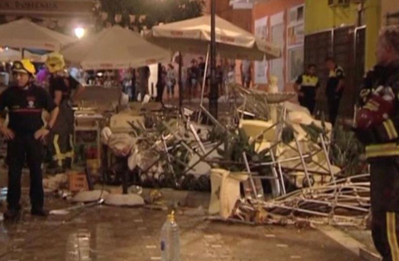 Police and rescue services are pictured at the scene after a gas cylinder exploded in a cafe in Velez-Malaga, Spain October 1, 2016 (photo credit: REUTERS)