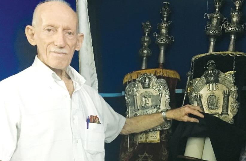 Simon Goldstein, first vice president of the B’nai B’rith Maimonides Lodge, displays the Torah scrolls kept in the Centro Sefaradi Hebreo (photo credit: JILL WAGNER)