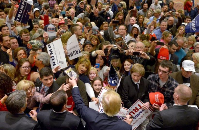 US Republican Presidential candidate Donald Trump signs autographs after speaking at a rally in Reno, Nevada January 10, 2016 (photo credit: REUTERS)