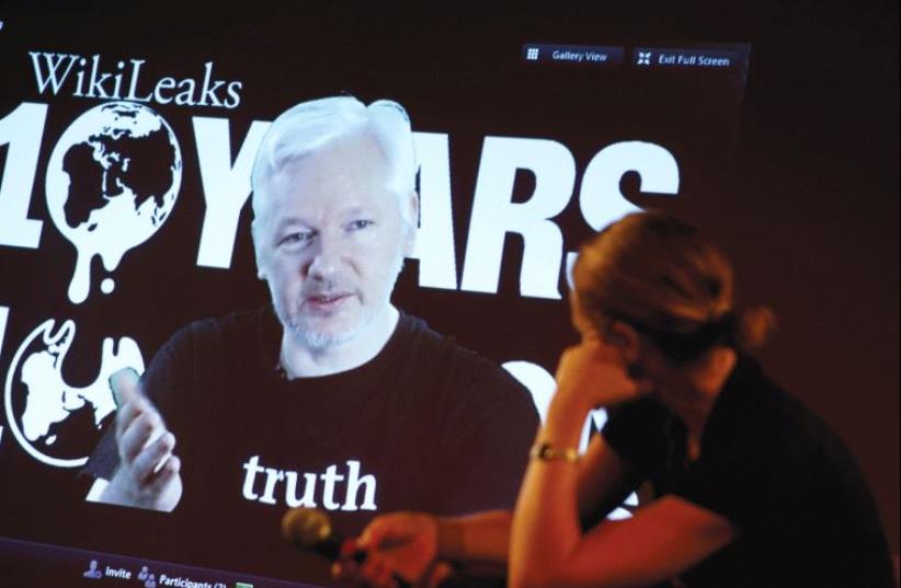 JULIAN ASSANGE, WikiLeaks founder and editor-in-chief, via video link, and Sarah Harrison, a WikiLeaks journalist, attend a press conference celebrating the organization’s 10th anniversary in Berlin on Tuesday. (photo credit: AXEL SCHMIDT/REUTERS)