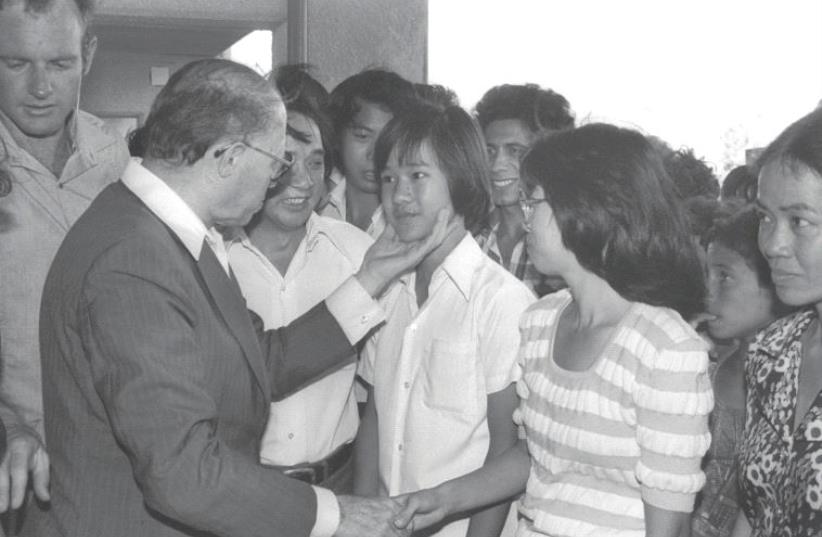 SHOULD ISRAEL take in Syrian refugees? Then-prime minister Menachem Begin visits Vietnamese refugees living in Afula in 1980. (photo credit: GPO)