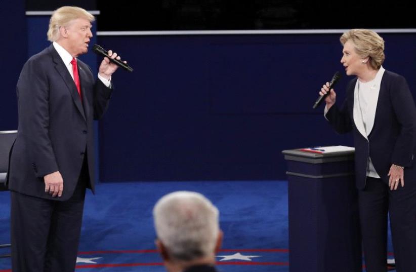 DATE IMPORTED: October 10, 2016 Republican U.S. presidential nominee Donald Trump and Democratic U.S. presidential nominee Hillary Clinton speak during their presidential town hall debate at Washington University in St. Louis, Missouri, U.S., October 9, 2016.  (photo credit: REUTERS)