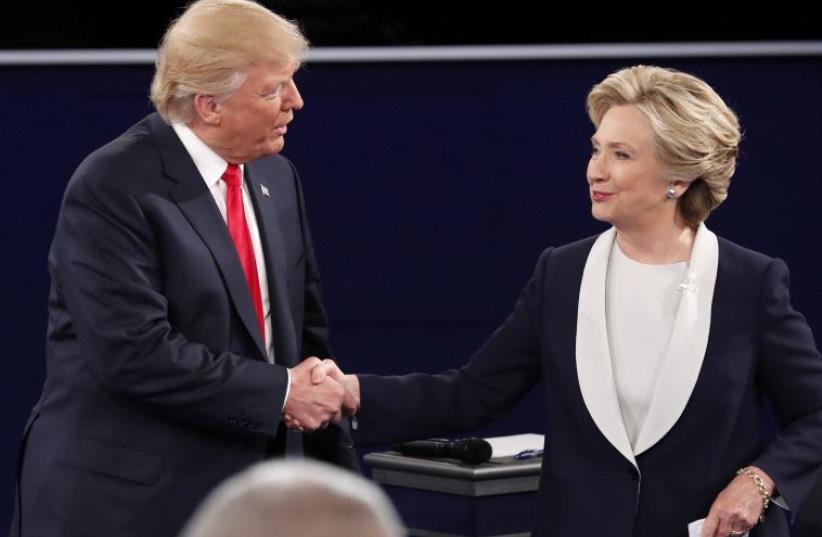 Republican US presidential nominee Donald Trump and Democratic U.S. presidential nominee Hillary Clinton shake hands at the conclusion of their presidential town hall debate at Washington University in St. Louis, Missouri, US, October 9, 2016 (photo credit: REUTERS)