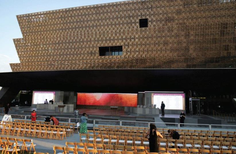 PEOPLE GATHER ahead of the dedication of the Smithsonian’s National Museum of African American History in Washington, D.C.  (photo credit: REUTERS)