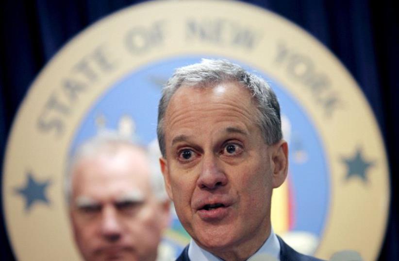 New York Attorney General Eric Schneiderman speaks at a news conference (photo credit: MIKE SEGAR / REUTERS)
