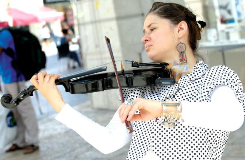 Tzipora Alexandra Kanarit, a.k.a. the gypsy lady, delights with her violin in Zion Square (photo credit: MARC ISRAEL SELLEM)